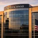 Charles Schwab stock rises late in the session as Fed minutes reshape rate bets
