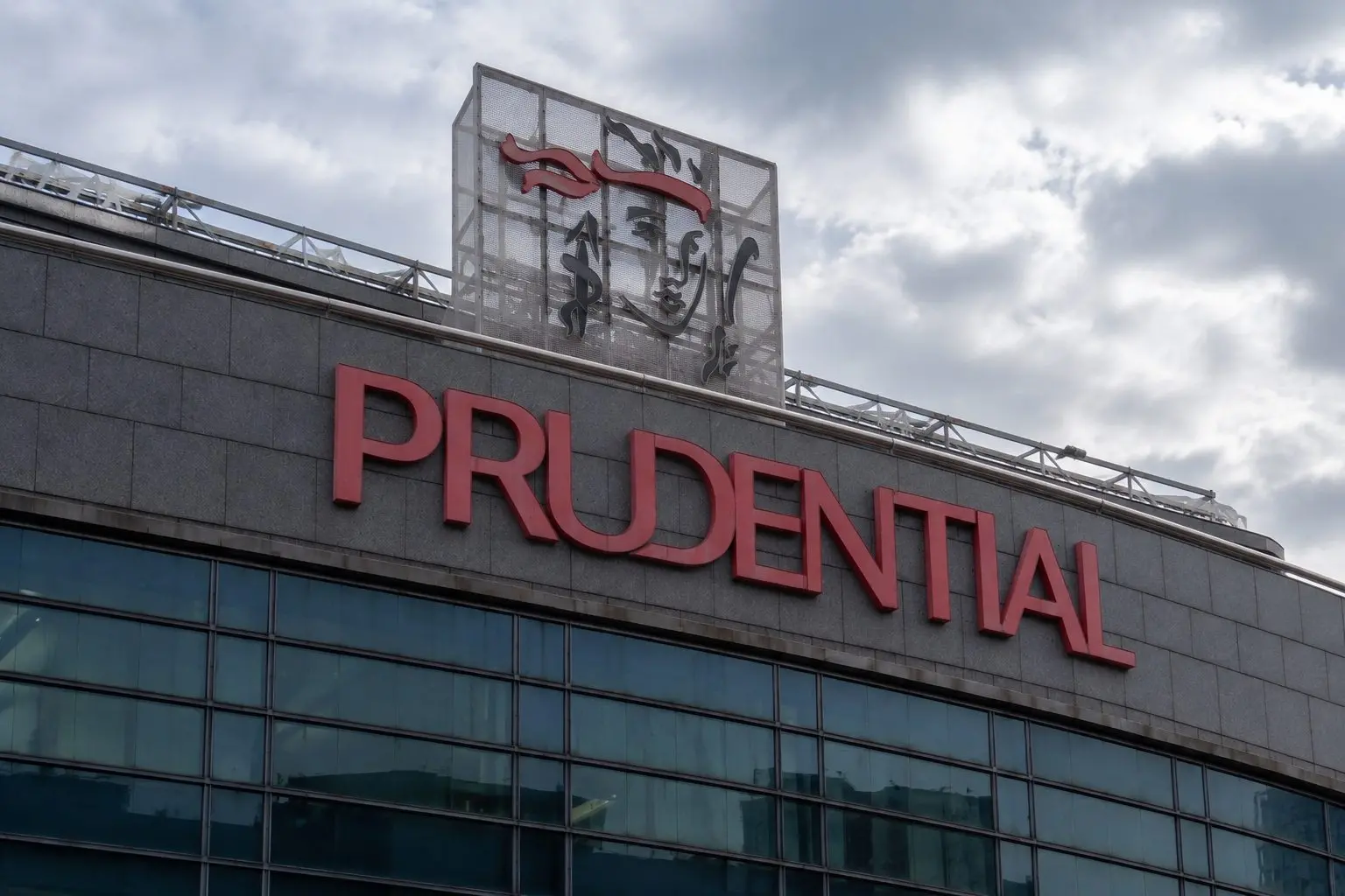 Prudential trades lower while shares buyback tops market price
